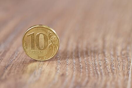 gold coin ten robles worth on the wooden floorの写真素材