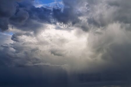 Sunlight is streaming through storm cloudsの写真素材