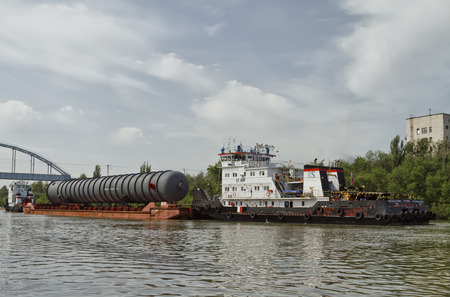 VOLGOGRAD - MAY 27: An oversized part of the column for the petrochemical industry on a barge on the...