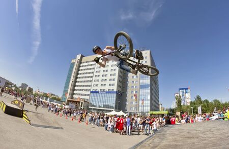 VOLGOGRAD - MAY 24: The BMX cyclist performs a stunt jump. The fifth annual competition for the Cup of Europe city Mall . May 24, 2015 in Volgograd, Russia.のeditorial素材