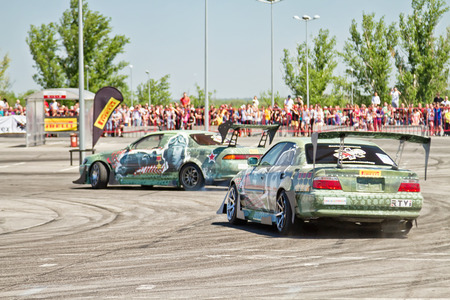 VOLGOGRAD - JUNE 6: Drift cars team X-Round enters the bend with slip during demonstrations as part of the tour on cities of Russia "Thank you for the victory!". June 6, 2015 in Volgograd, Russia.のeditorial素材