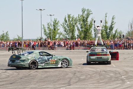 VOLGOGRAD - JUNE 6: Pilot drift team X-Round performs risky stunt climbs to the roof of the car while driving. June 6, 2015 in Volgograd, Russia.のeditorial素材