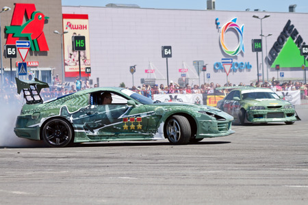 VOLGOGRAD - JUNE 6: Drift cars team X-Round enters the bend with slip during demonstrations as part of the tour on cities of Russia "Thank you for the victory!". June 6, 2015 in Volgograd, Russia.のeditorial素材