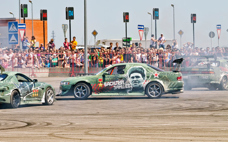 VOLGOGRAD - JUNE 6: Drift cars team X-Round enters the bend with slip during demonstrations as part of the tour on cities of Russia "Thank you for the victory!". June 6, 2015 in Volgograd, Russia.のeditorial素材