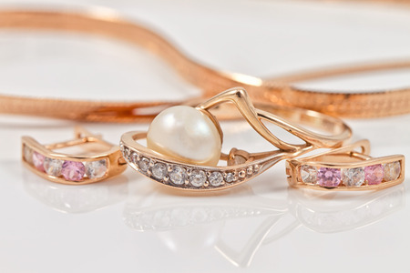 The set of gold earrings with a beautiful gold ringの写真素材