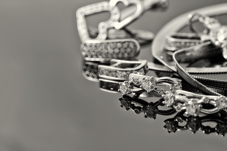 Gold earrings of different sizes and shapes lie in a rowの写真素材