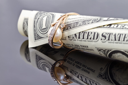 gold ring dressed on the banknote one dollarの写真素材