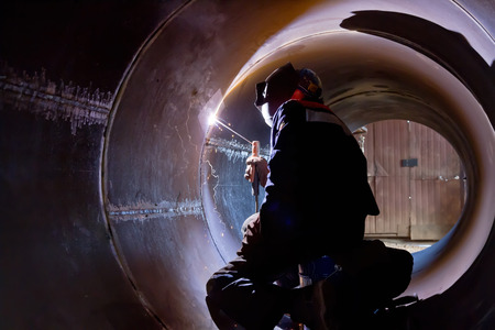 The welder weld root weld from inside of the housing of  chemical apparatus