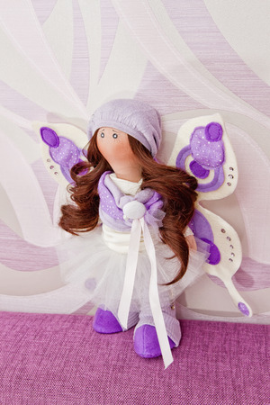 Collectible rag doll with fairy wings. Doll decorated with rhinestones, she has wings and natural hair to create hairstylesの写真素材