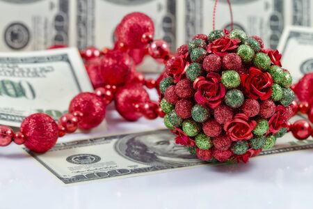 Decorations for the Christmas tree on the background of hundred dollar billsの写真素材