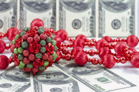 Decorations for the Christmas tree on the background of hundred dollar billsの写真素材