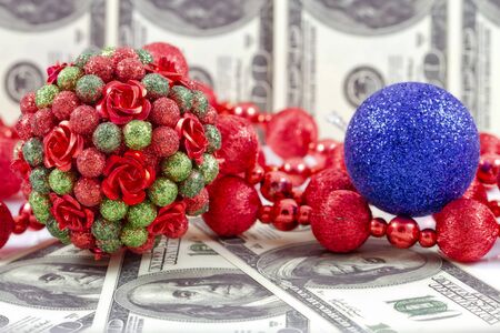 Decorations for the Christmas tree on the background of hundred dollar billsの写真素材