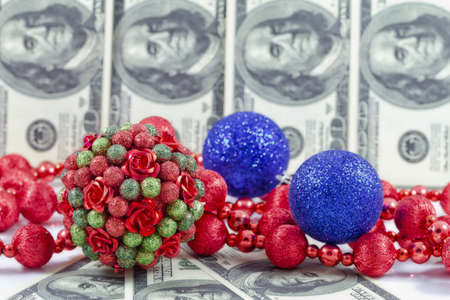 Decorations for the Christmas tree on the background of hundred dollar billsの写真素材