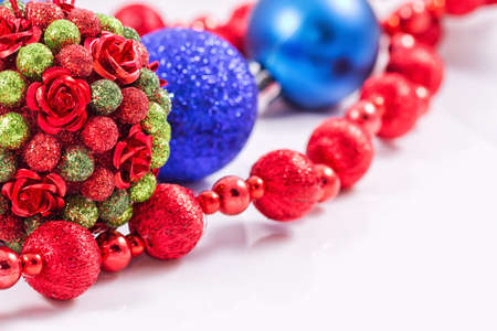 Christmas tree toy is decorated with sequins and decorative rosettes along with red garlandの写真素材
