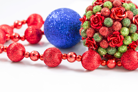 Christmas tree toy is decorated with sequins and decorative rosettes along with red garlandの写真素材
