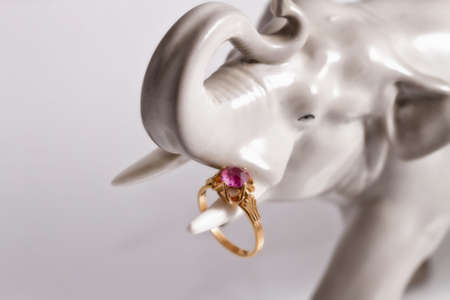 Porcelain statuette of an elephant holding a Tusk gold ring with amethystの写真素材