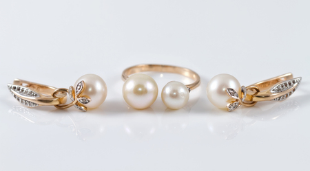 The set of gold earrings with a beautiful gold ringの写真素材