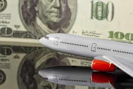 Concept :rise of freight and passenger traffic in the world. Figure the plane on the background of hundred-dollar bills.の写真素材