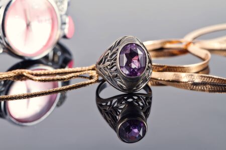 Gold chain snake netting and silver ring with amethystの写真素材