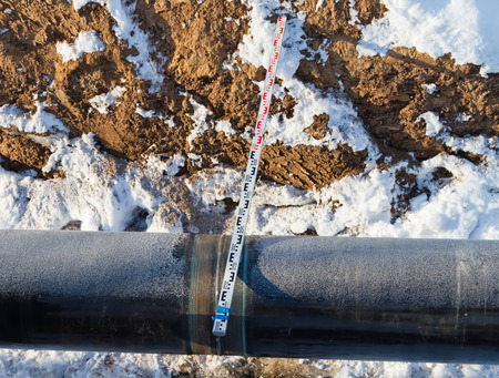 Measurement of geometrical quantities of the main pipeline laid in trench in winterの写真素材