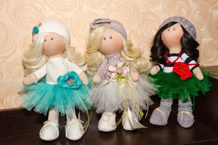 Textile dolls handmade on a stand wooden shelf Cabinetの写真素材