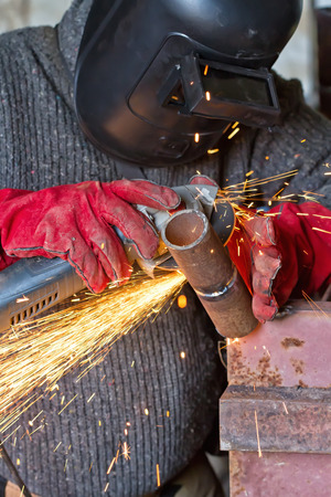 The welder handles the root seam with a cutting machine. Preparing for the facing seam to the control sample.の写真素材