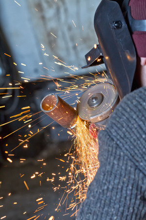 The welder handles the root seam with a cutting machine. Preparing for the facing seam to the control sample.の写真素材