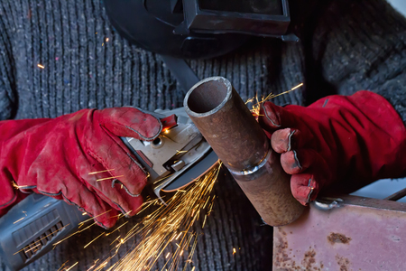The welder handles the root seam with a cutting machine. Preparing for the facing seam to the control sample.の写真素材