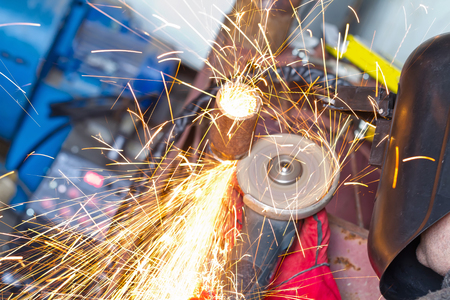 The welder handles the root seam with a cutting machine. Preparing for the facing seam to the control sample.の写真素材