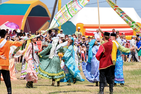 SMALL CHAPURNIKI, VOLGOGRAD, RUSSIA - MAY 24: Young boys and girls dressed in traditional costumes dancing folk dances at the celebration of the Sabantuy. May 24, 2014 in Volgograd, Russia.のeditorial素材
