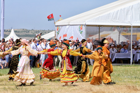 SMALL CHAPURNIKI, VOLGOGRAD, RUSSIA - MAY 24: Young girls dressed in traditional costumes dancing folk dances at the celebration of the Sabantuy. May 24, 2014 in Volgograd, Russia.のeditorial素材