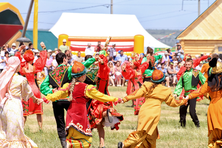 SMALL CHAPURNIKI, VOLGOGRAD, RUSSIA - MAY 24: Young boys and girls dressed in traditional costumes dancing folk dances at the celebration of the Sabantuy. May 24, 2014 in Volgograd, Russia.のeditorial素材