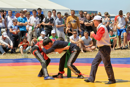 SMALL CHAPURNIKI, VOLGOGRAD, RUSSIA - MAY 24:Traditional Tatar belt wrestling Koresh, the tournament between the youth at the Sabantuy. May 24, 2014 in Volgograd, Russia.のeditorial素材