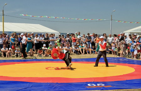 SMALL CHAPURNIKI, VOLGOGRAD, RUSSIA - MAY 24:Traditional Tatar belt wrestling Koresh, the tournament between the youth at the Sabantuy. May 24, 2014 in Volgograd, Russia.のeditorial素材