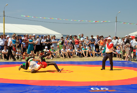SMALL CHAPURNIKI, VOLGOGRAD, RUSSIA - MAY 24:Traditional Tatar belt wrestling Koresh, the tournament between the youth at the Sabantuy. May 24, 2014 in Volgograd, Russia.のeditorial素材