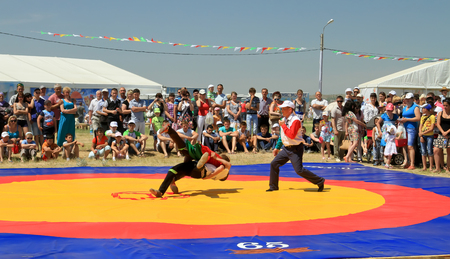 SMALL CHAPURNIKI, VOLGOGRAD, RUSSIA - MAY 24:Traditional Tatar belt wrestling Koresh, the tournament between the youth at the Sabantuy. May 24, 2014 in Volgograd, Russia.のeditorial素材