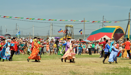 SMALL CHAPURNIKI, VOLGOGRAD, RUSSIA - MAY 24: Young boys and girls dressed in traditional costumes dancing folk dances at the celebration of the Sabantuy. May 24, 2014 in Volgograd, Russia.のeditorial素材