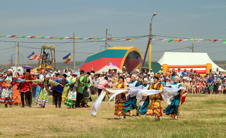 SMALL CHAPURNIKI, VOLGOGRAD, RUSSIA - MAY 24: Young boys and girls dressed in traditional costumes dancing folk dances at the celebration of the Sabantuy. May 24, 2014 in Volgograd, Russia.のeditorial素材
