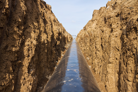 pipeline is in the protective insulation laid on the bottom of the trench dug. Photograph from the trenchの写真素材