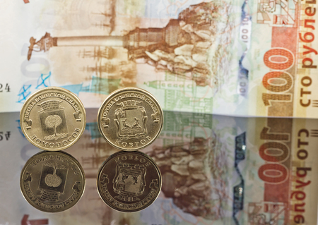 Commemorative coins 10 rubles cities of military glory Lomonosov and Carpets on the background of the banknote in a hundred rubles on the accession of Crimea to Russiaの写真素材
