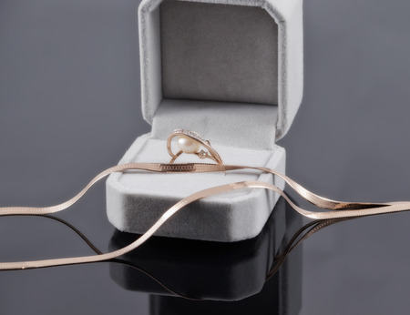 Gold engagement ring gift box with gold chainの写真素材