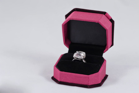 Silver ring with a large precious stone in a grey gift boxの写真素材
