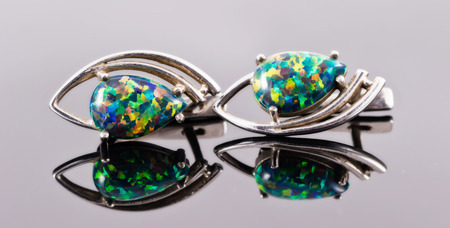 Silver earrings in the shape of human eyes with multi-colored semi-precious stonesの写真素材