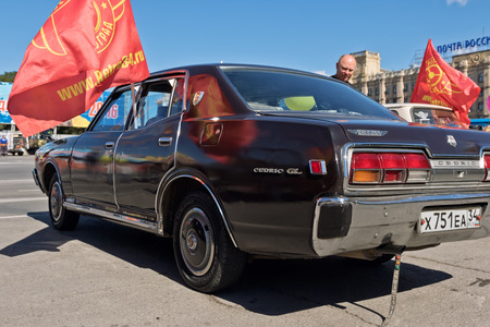 VOLGOGRAD - SEPTEMBER 10: Nissan Cedric GL dark colours at the exhibition of vintage cars under the open sky. September 10, 2016 in Volgograd, Russia.のeditorial素材