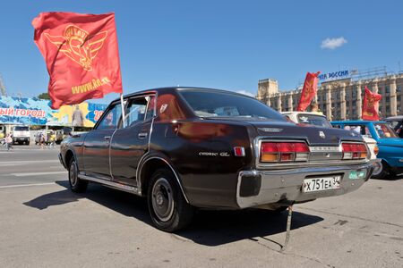 VOLGOGRAD - SEPTEMBER 10: Nissan Cedric GL dark colours at the exhibition of vintage cars under the open sky. September 10, 2016 in Volgograd, Russia.のeditorial素材
