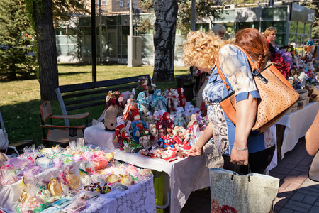 VOLGOGRAD - SEPTEMBER 10: Exhibition-sale of dolls and handmade Souvenirs on the streets during the celebration of city day. September 10, 2016 in Volgograd, Russia.のeditorial素材