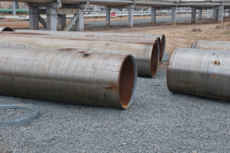 Large diameter pipes lying on the gravel on the spot welding of the pipelineの写真素材