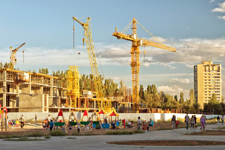 VOLGOGRAD - SEPTEMBER 9: The construction of a new monolithic apartment house near a Playground...