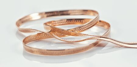 Gold chain with a weave reminiscent of a snake's skinの写真素材