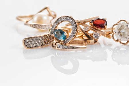 A variety of gold jewelry : rings, earrings with Topaz and pearlsの写真素材